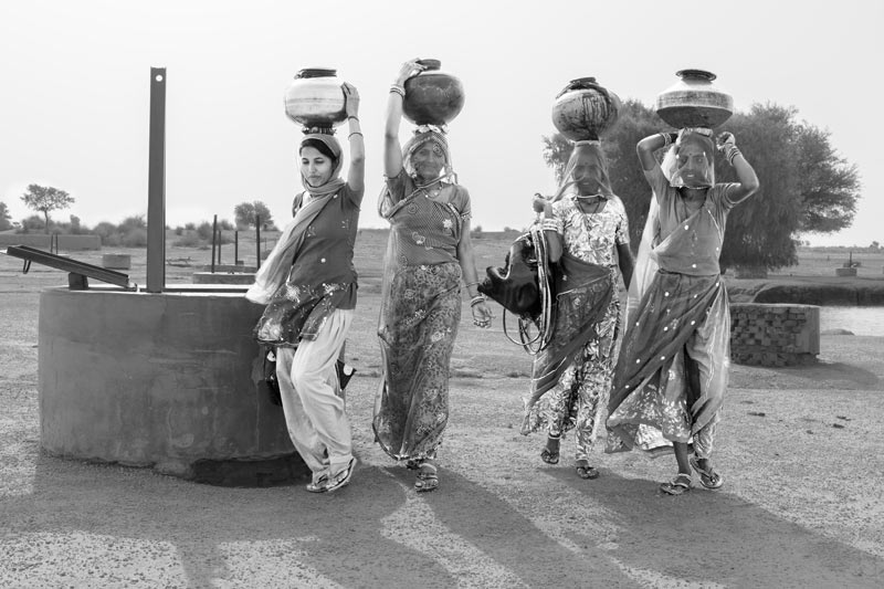 Heading home with sweet drinking water for the family from a 'kuin'(shallow well) - village Binjharwali, Bikaner district, Rajasthan